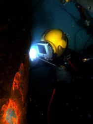Hot work  ...US Navy diver welds a plate on the bow of a ... by Andrew Mckaskle 